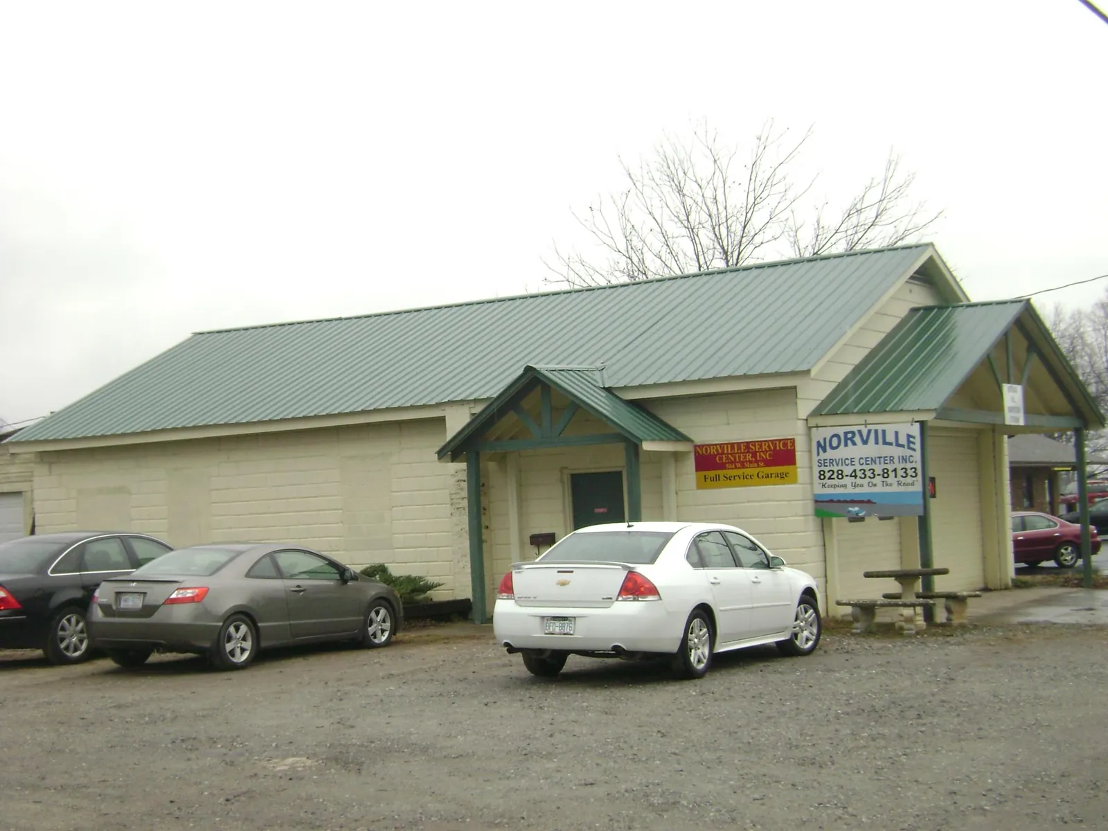 Green metal roof on a service garage with a covered entry in Bolivar